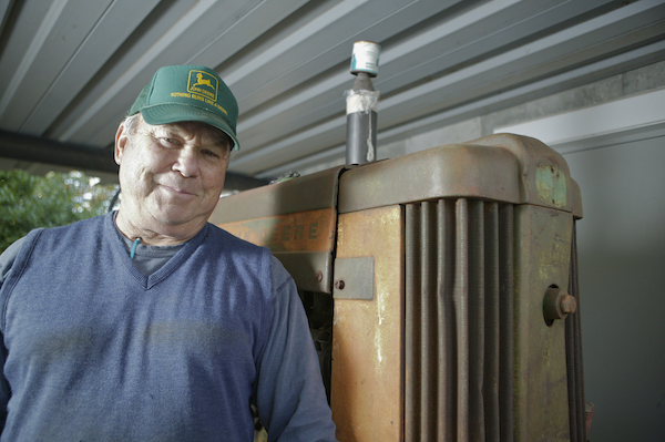 Paul Waltral poses with a John Deere tractor