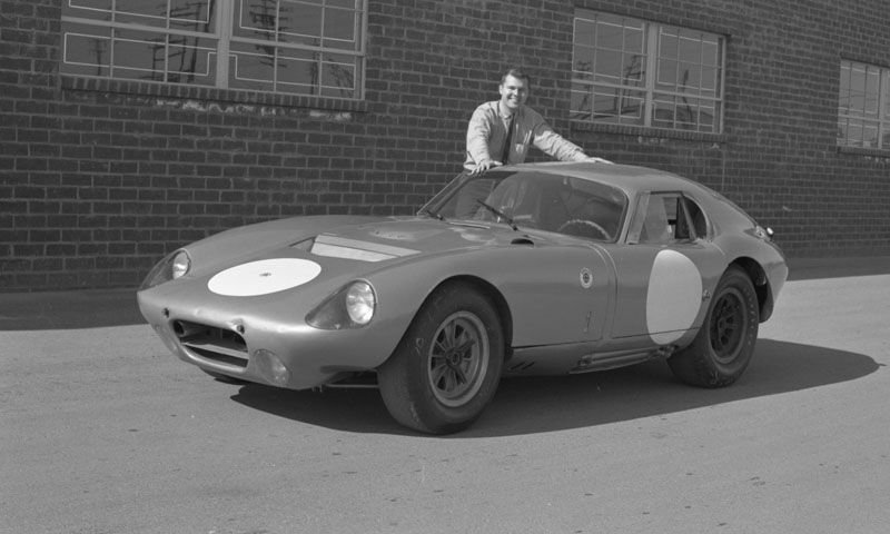 peter brock in front of daytona coupe