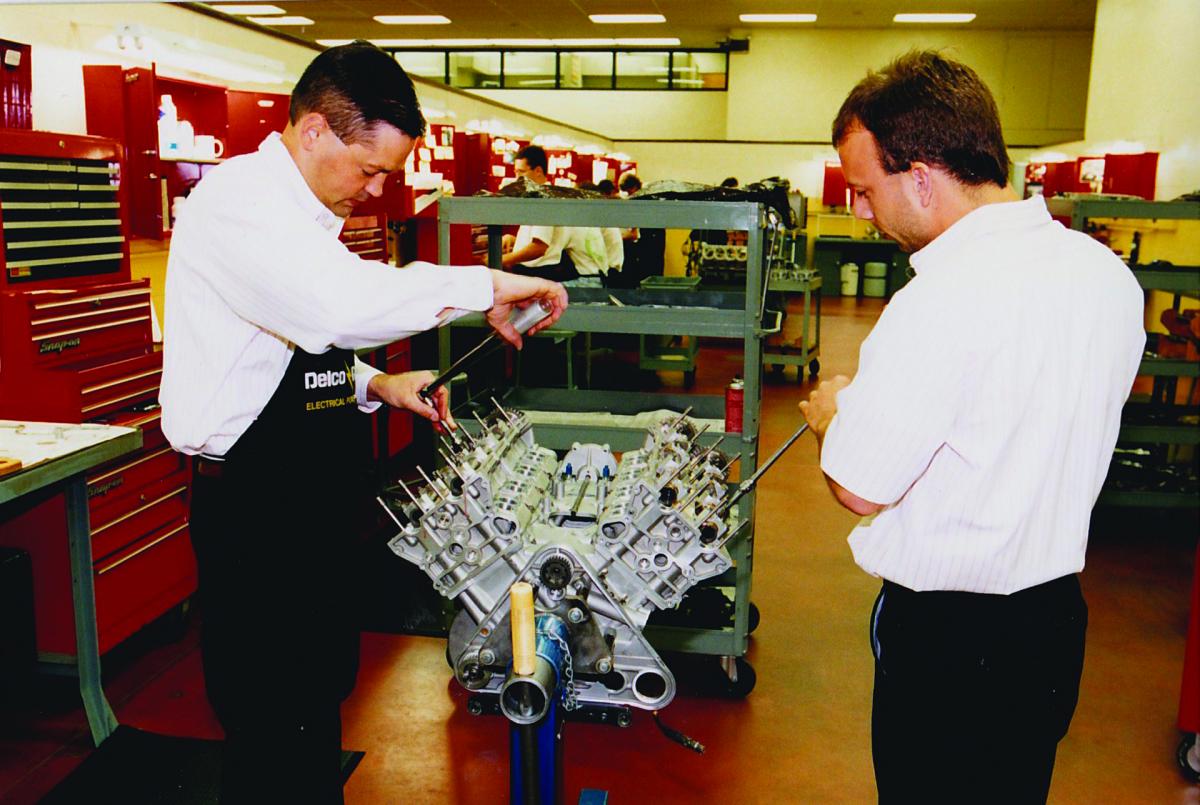 Image of men working on engine