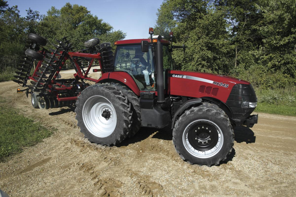 An MX245 Magnum tractor with front and rear duals tows a folding tandem disc harrow. Directly under the plastic toolbox is the battery access panel. (Photo curtesy of Case IH)